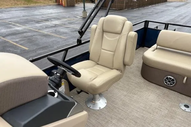 Slide: The Image of 2025 Regency 250 DL3 boat interior with beige captain's chair and seating. - 26