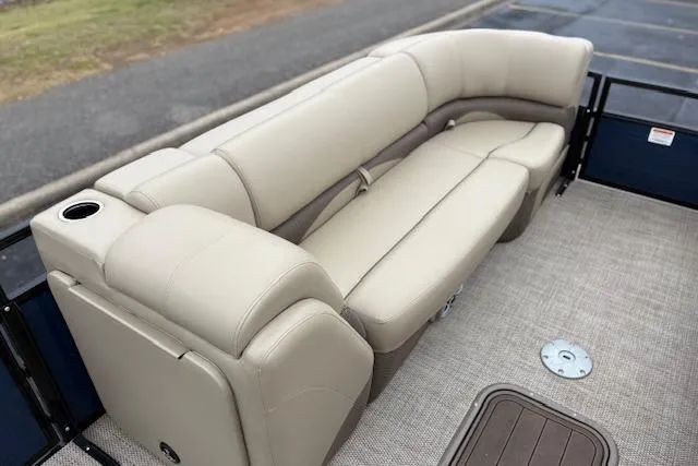 Slide: The Image of 2025 Regency 250 DL3 pontoon boat with beige seating and cup holder. - 29