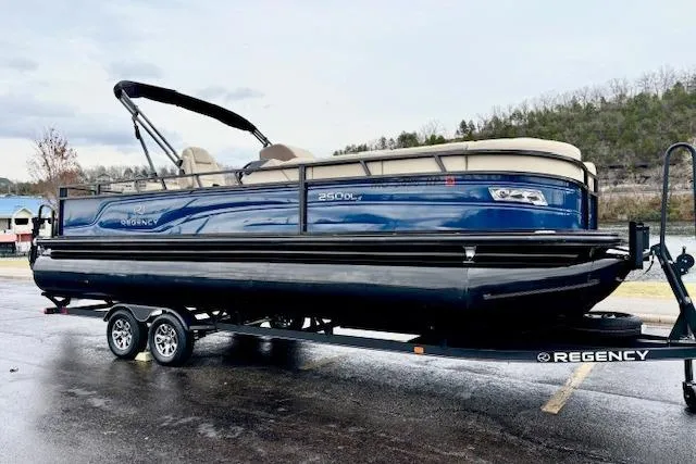 Slide: The Image of 2025 Regency 250 DL3 pontoon boat on trailer, parked outdoors. - 3