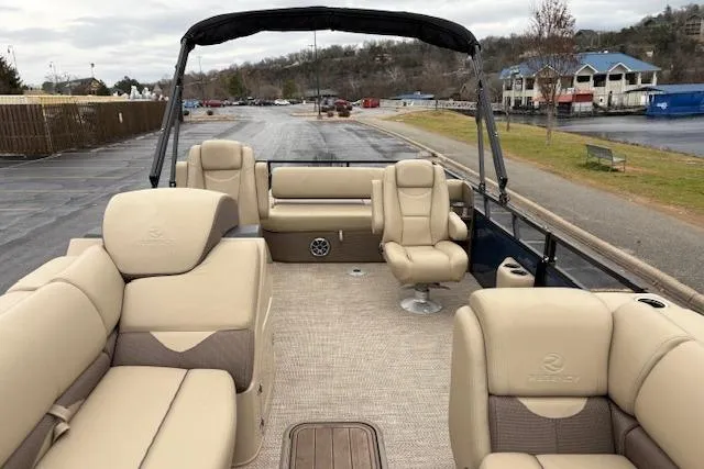 Slide: The Image of 2025 Regency 250 DL3 pontoon boat with beige seating and spacious deck layout. - 30
