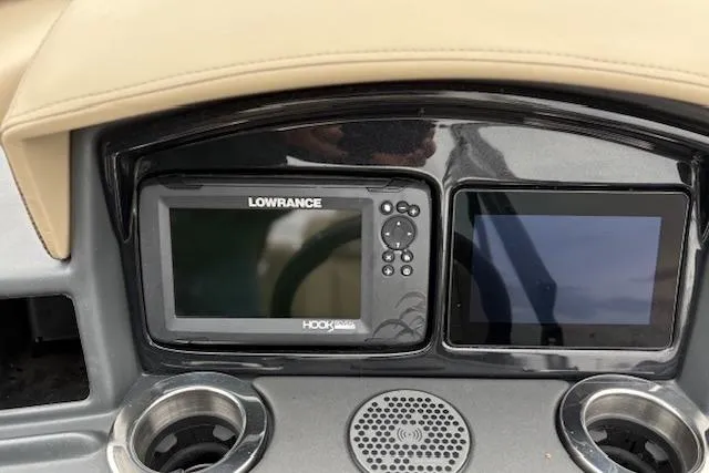 Slide: The Image of Dashboard of 2025 Regency 250 DL3 with Lowrance Hook fish finder and dual cup holders. - 32