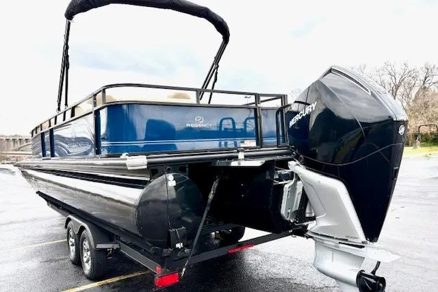Slide: The Image of 2025 Regency 250 DL3 pontoon boat with Mercury outboard engine on a trailer. - 9