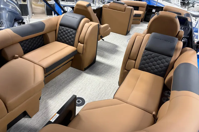 Slide: The Image of Luxurious interior of 2026 South Bay 525RS pontoon boat with tan and black seating. - 10