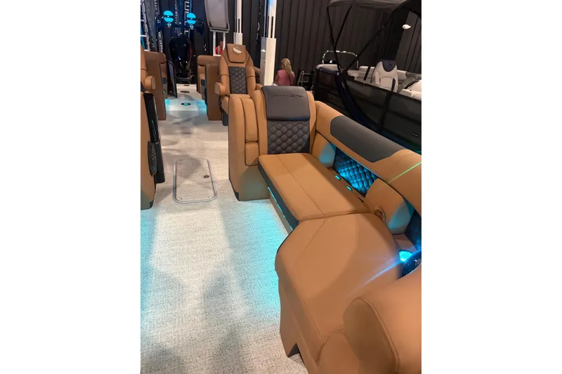 Slide: The Image of Luxurious interior of 2026 South Bay 525RS boat with tan leather seating and ambient lighting. - 11