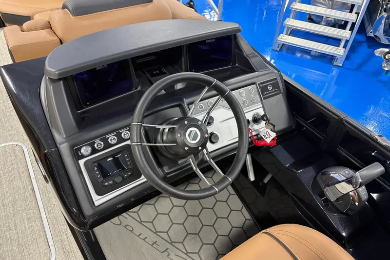 Slide: The Image of 2026 South Bay 525RS boat dashboard with steering wheel and control panel. - 6