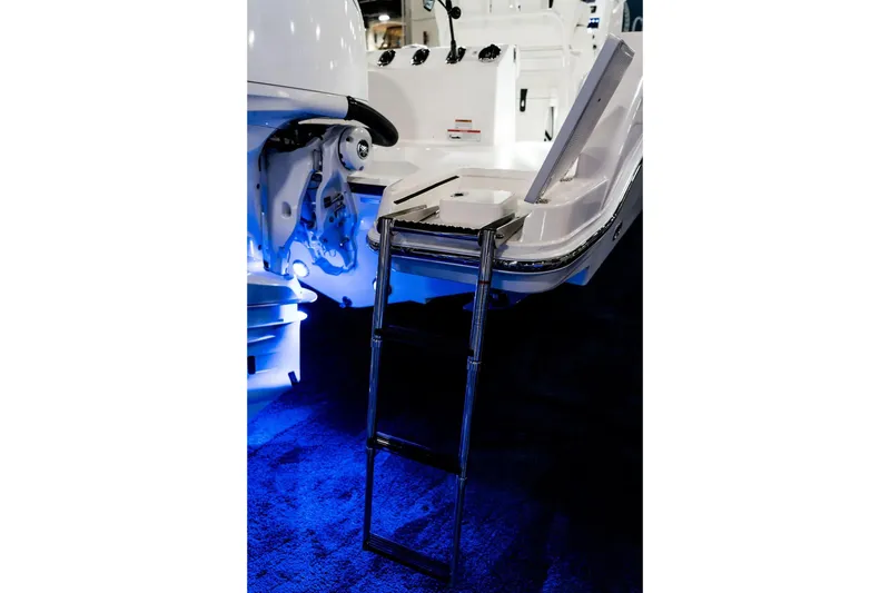 Slide: The Image of 2026 Edgewater 230CC boat with a foldable ladder and illuminated deck. - 11