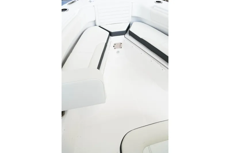 Slide: The Image of Interior view of 2026 Edgewater 230CC boat, featuring white seating and sleek design. - 12