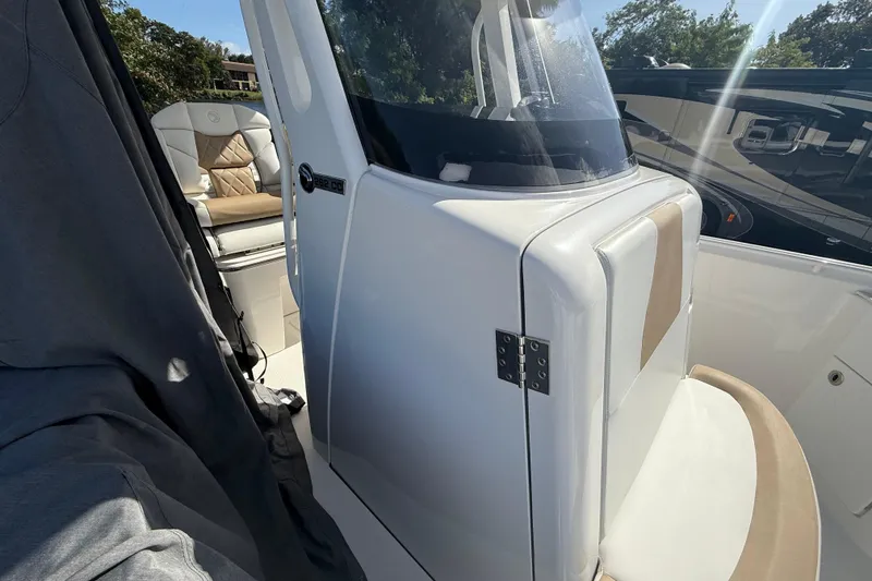 Slide: The Image of 2021 Edgewater 262CC boat interior with seating and console details. - 11