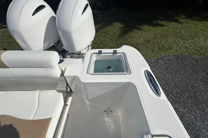 Slide: The Image of 2021 Edgewater 262CC boat with dual engines and seating area. - 14