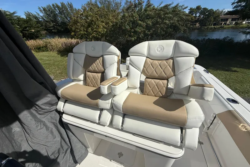 Slide: The Image of Luxurious seating on 2021 Edgewater 262CC boat, featuring tan and white upholstery. - 7