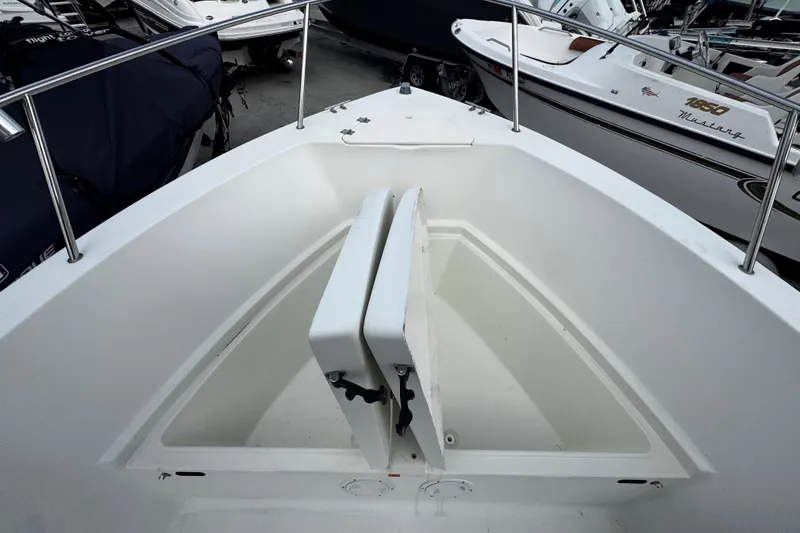 Slide: The Image of 2023 Hydra-Sports 212 CC boat interior with open storage compartment, surrounded by other boats. - 15