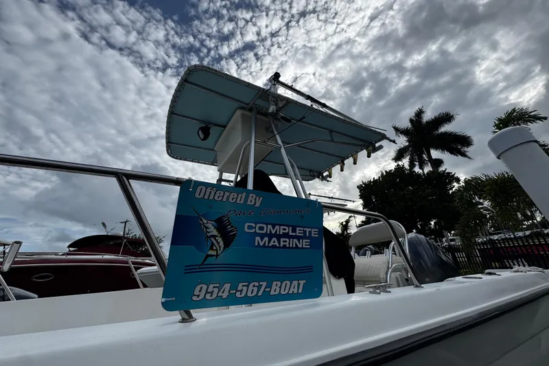 Slide: The Image of 2023 Hydra-Sports 212 CC boat with Complete Marine sign, under cloudy sky. - 4