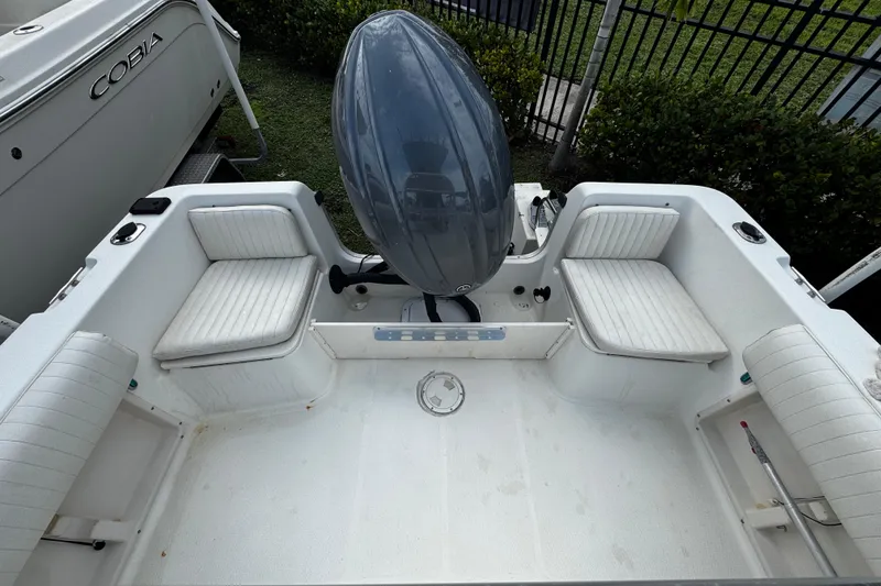 Slide: The Image of 2023 Hydra-Sports 212 CC boat interior with seating and outboard motor. - 5