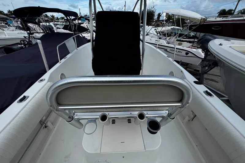 Slide: The Image of 2023 Hydra-Sports 212 CC boat interior with seating and rod holders, docked among other boats. - 6