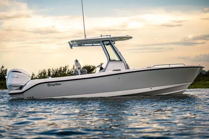 The Image of 2026 Edgewater 250CC boat on water at sunset, showcasing sleek design and modern features. - 1