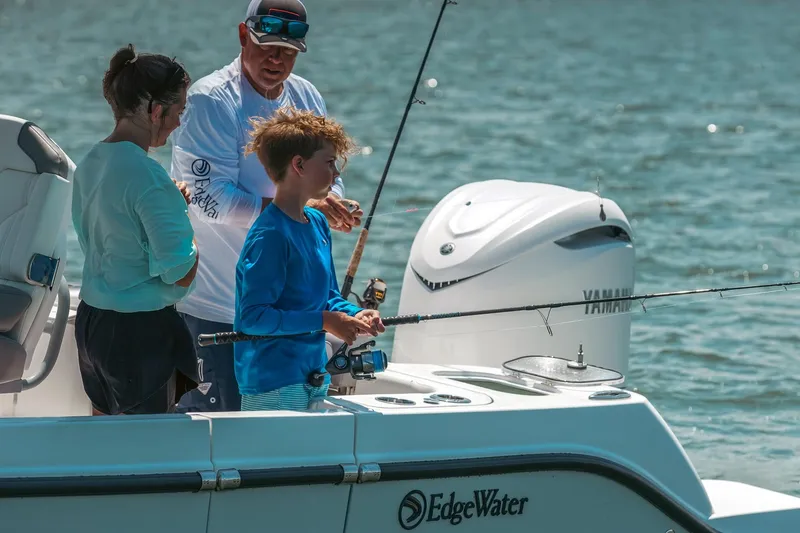 Slide: The Image of Family fishing on 2026 Edgewater 250CC boat, enjoying a sunny day on the water. - 10