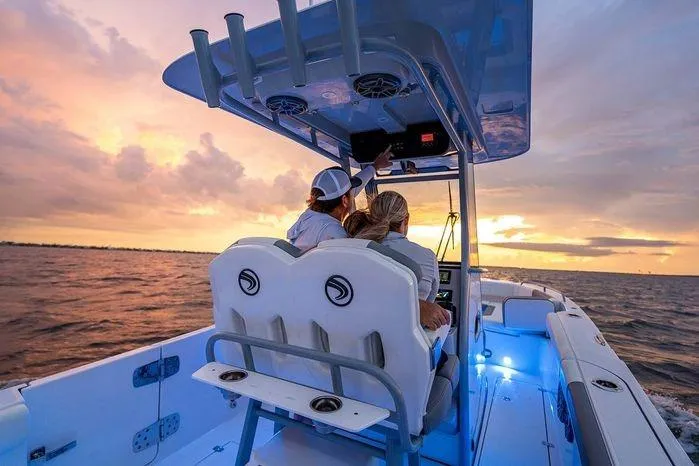 Slide: The Image of 2026 Edgewater 250CC boat cruising at sunset with passengers enjoying the view. - 5