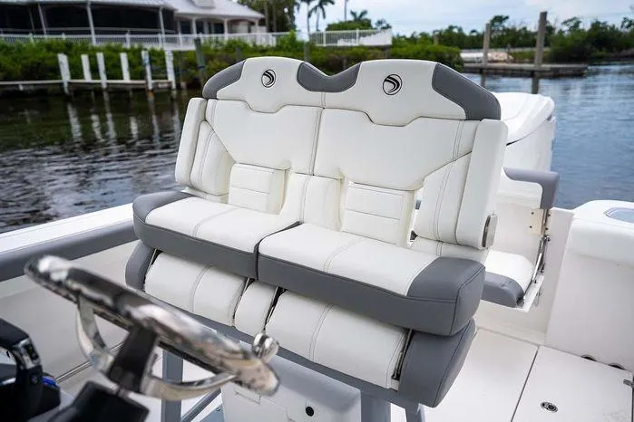 Slide: The Image of Luxury seating on 2026 Edgewater 250CC boat, featuring plush white and gray upholstery. - 7