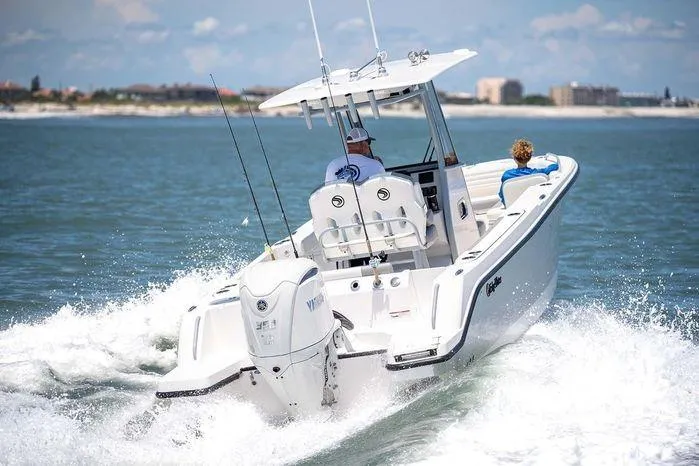 Slide: The Image of 2026 Edgewater 250CC boat cruising on open water with two passengers. - 9