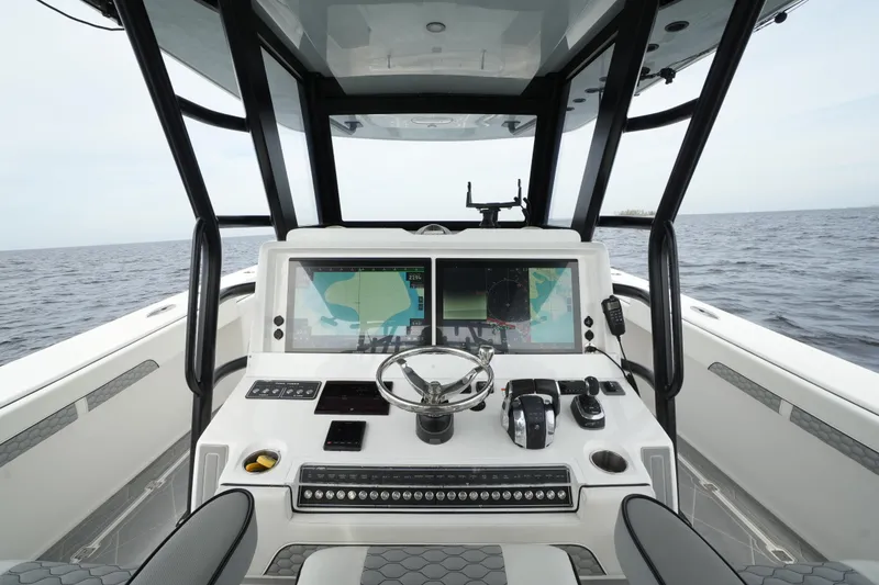 Slide: The Image of Invincible 46 Catamaran 2022 helm with dual screens and ocean view. - 15