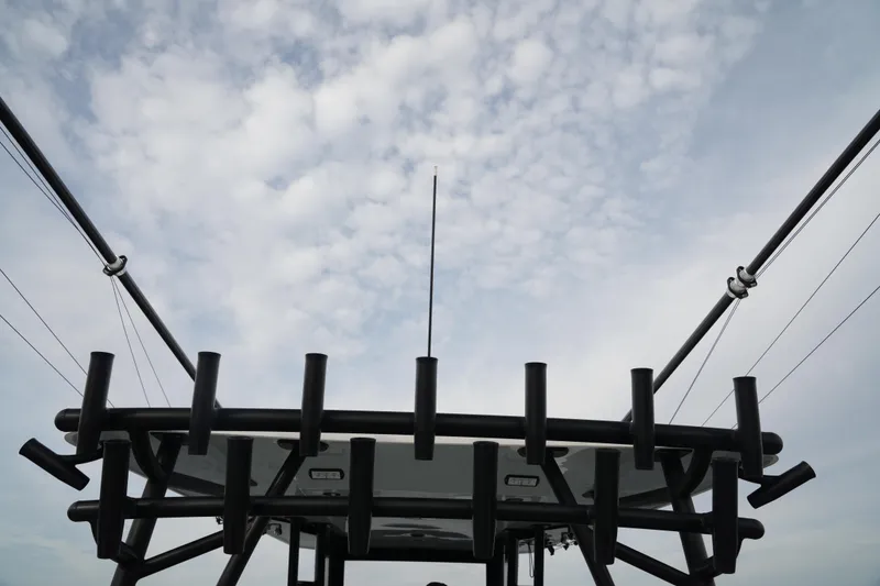 Slide: The Image of Invincible 46 Catamaran 2022, fishing rod holders against cloudy sky. - 18