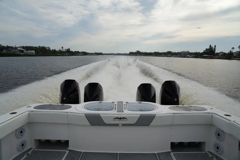 Slide: The Image of Invincible 46 Catamaran 2022 cruising on a calm river with powerful engines. - 30