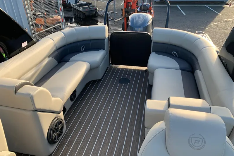 Slide: The Image of 2023 Premier 250 SunSation RF pontoon boat interior with plush seating and striped flooring. - 11