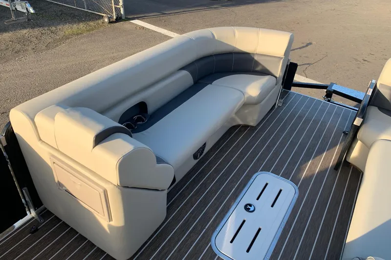 Slide: The Image of 2023 Premier 250 SunSation RF boat interior with beige seating and striped flooring. - 14