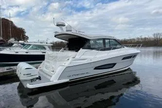 Slide: The Image of 2021 Regal 38 XO boat with Yamaha outboard engines docked at marina. - 11