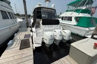 Slide: The Image of 2021 Regal 38 XO boat with Yamaha outboard engines, docked at a marina. - 18