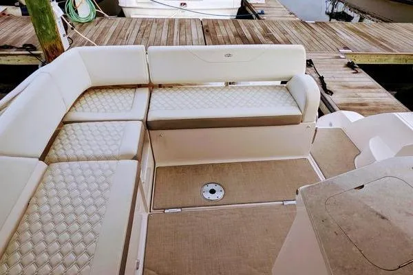 Slide: The Image of 2021 Regal 38 XO boat interior with covered seating and sleek flooring. - 22