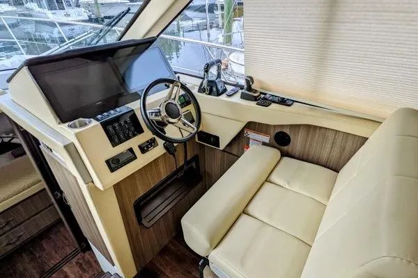 Slide: The Image of 2021 Regal 38 XO helm with modern controls and navigation display. - 29
