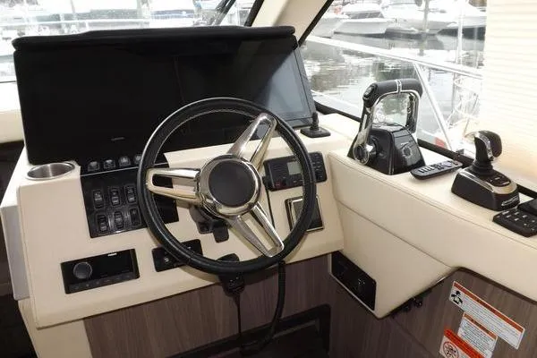 Slide: The Image of Helm of 2021 Regal 38 XO boat with dual screens and controls. - 30