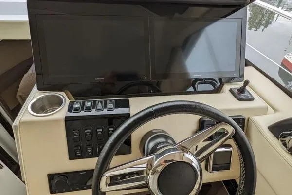 Slide: The Image of Control panel of a 2021 Regal 38 XO yacht with joystick and throttle. - 31
