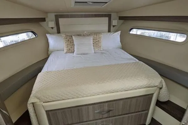 Slide: The Image of Interior cabin of 2021 Regal 38 XO yacht with bed and wall-mounted TV. - 34