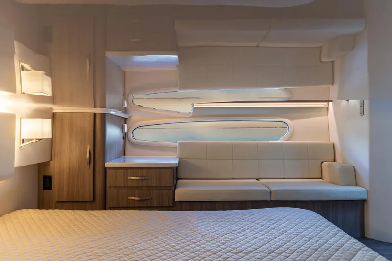 Slide: The Image of Interior of 2021 Regal 38 XO yacht with beige seating and mattress. - 40