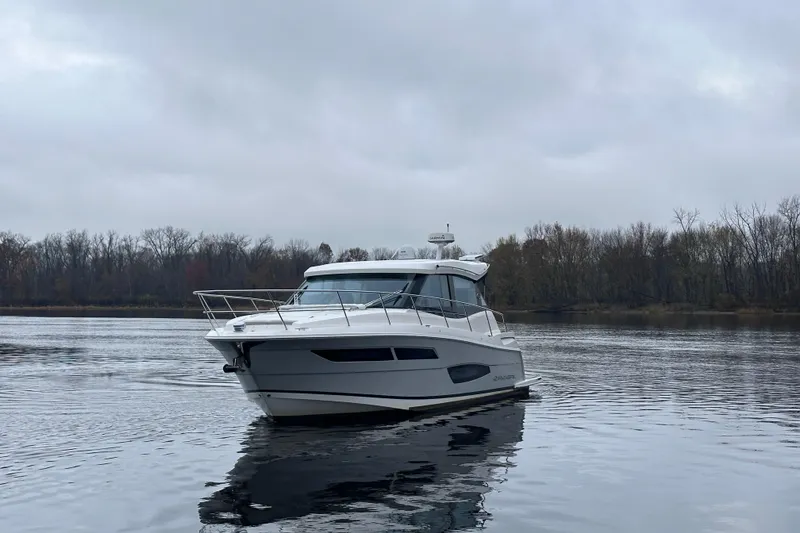 Slide: The Image of 2021 Regal 38 XO yacht on a calm lake under overcast skies. - 6