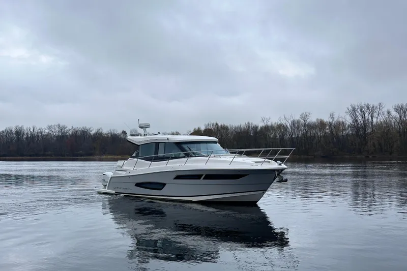 Slide: The Image of 2021 Regal 38 XO yacht on calm water under cloudy sky. - 8