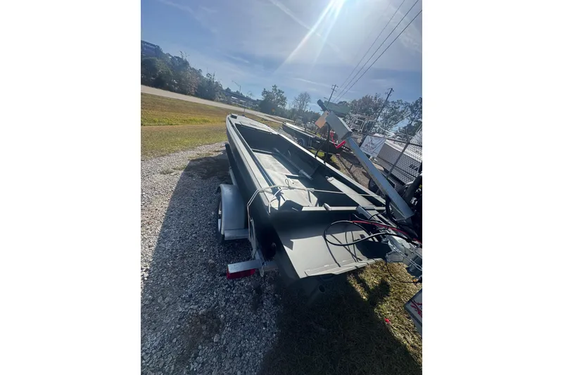 The Image of 2026 Go-Devil 18x54 Surface Drive Boat on trailer under bright sunlight. - 1