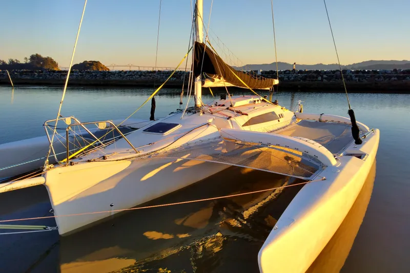 The Image of 2005 Corsair F-31 1D trimaran sailboat docked at sunset, calm waters. - 1