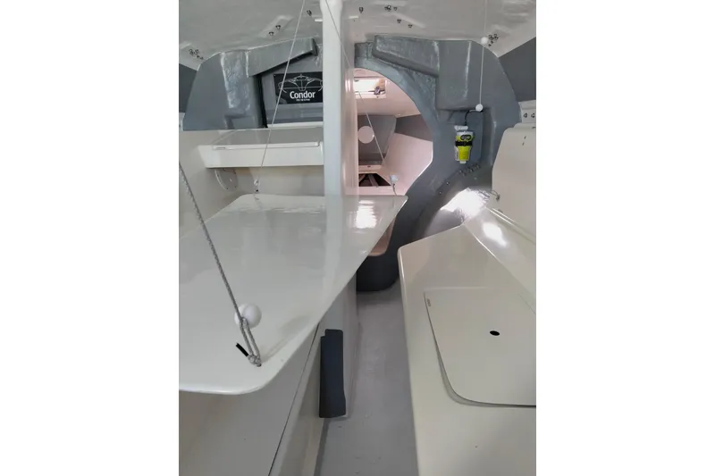 Slide: The Image of Interior of 2005 Corsair F-31 1D sailboat, featuring sleek white and gray design. - 14