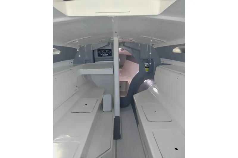 Slide: The Image of Interior of 2005 Corsair F-31 1D sailboat, featuring sleek white cabin design. - 16