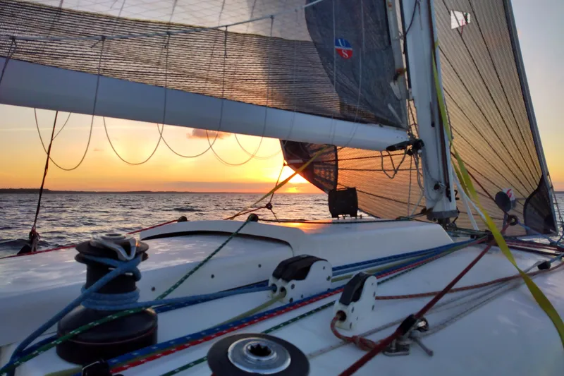 Slide: The Image of Sailing on Corsair F-31 1D at sunset, vibrant ropes and sails in view. - 3