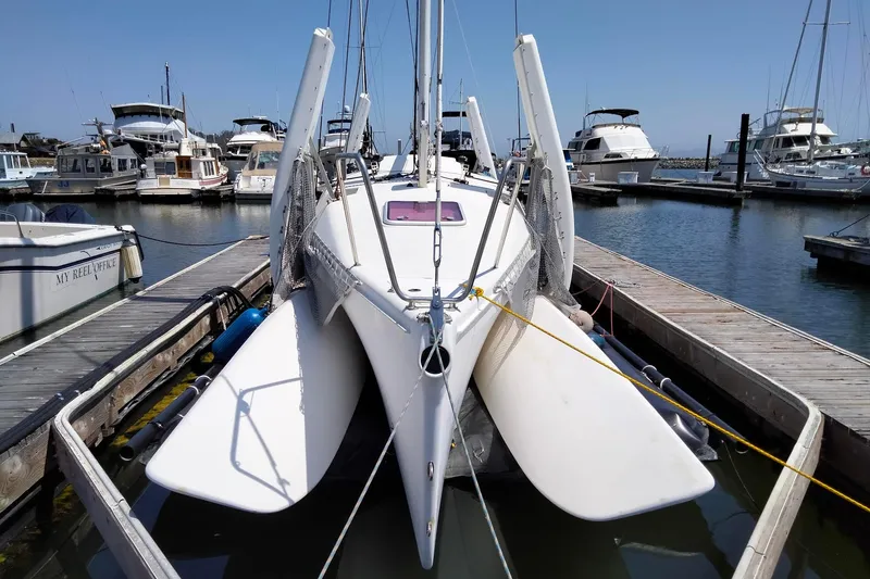 Slide: The Image of 2005 Corsair F-31 1D trimaran docked at marina with other boats. - 7