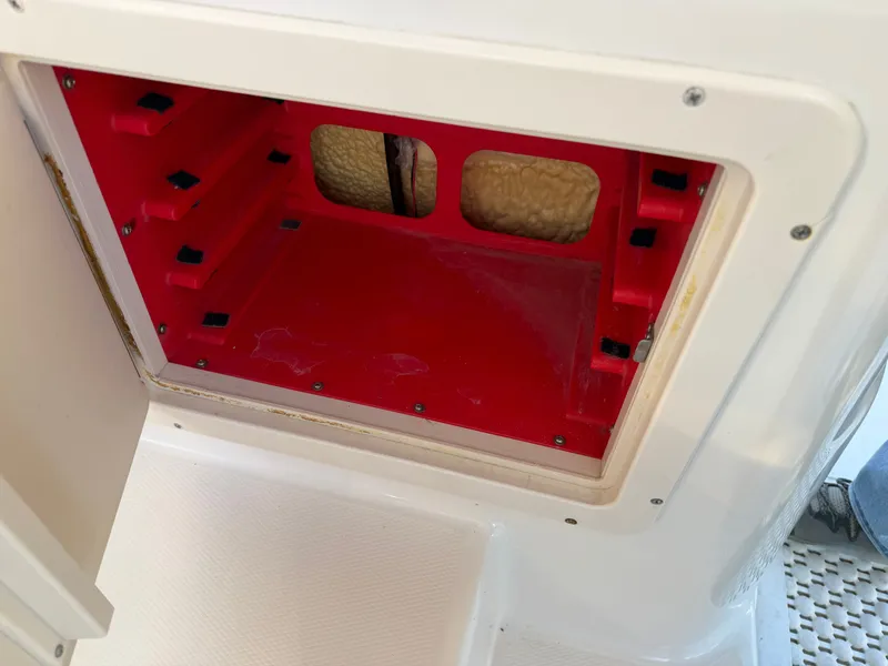 Slide: The Image of Red storage compartment in 2004 Grady-White Express 330 boat. - 12