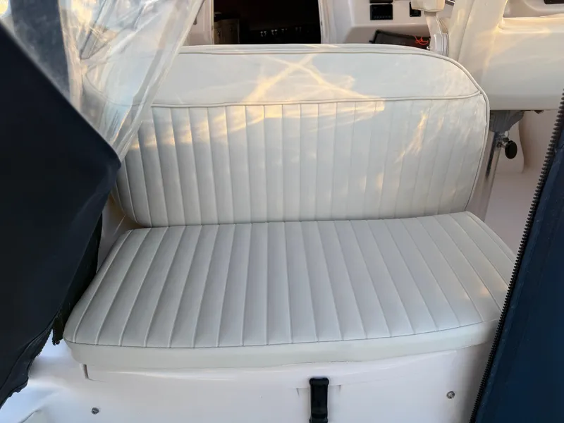 Slide: The Image of Interior of 2004 Grady-White Express 330 boat, featuring a cushioned seat. - 21