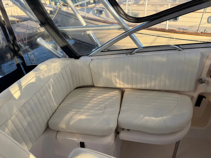 Slide: The Image of Interior of a 2004 Grady-White Express 330 with beige upholstered seating. - 23