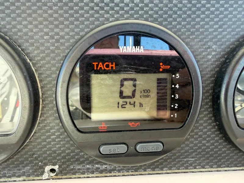 Slide: The Image of Yamaha tachometer on 2004 Grady-White Express 330 showing 124 hours. - 26