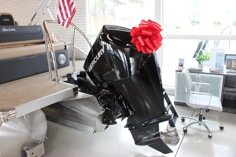 Slide: The Image of 2026 Barletta C24U pontoon boat with Mercury engine, red bow, and American flag. - 10