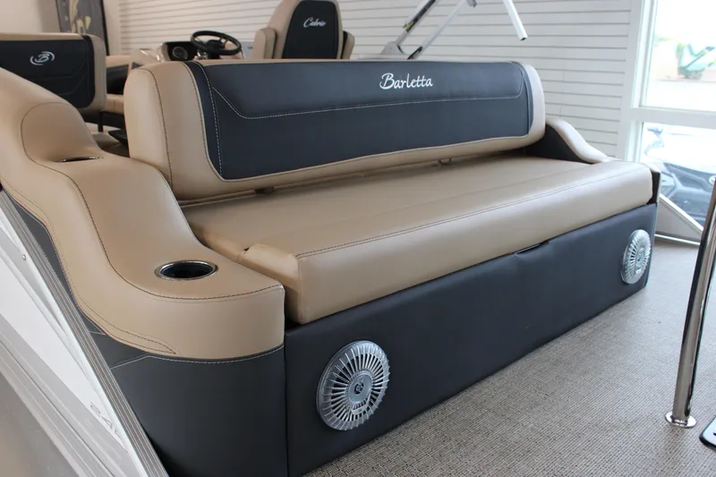 Slide: The Image of 2026 Barletta C24U boat interior with beige and black seating, cup holders, and speakers. - 11